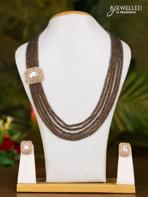 Beaded brown necklace with white stone pendant