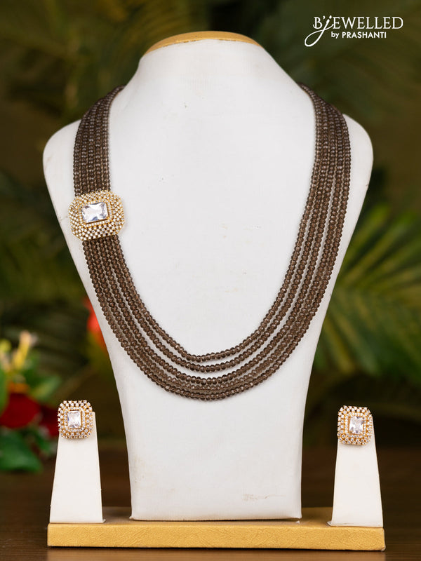 Beaded brown necklace with white stone pendant
