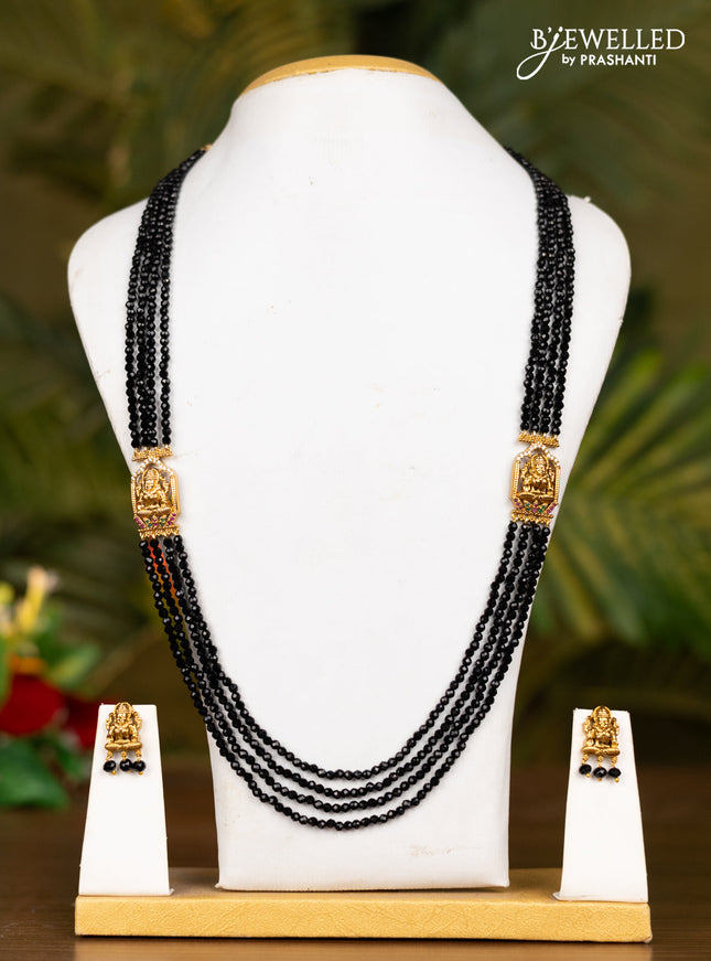 Beaded black necklace with antique lakshmi pendant in white stones