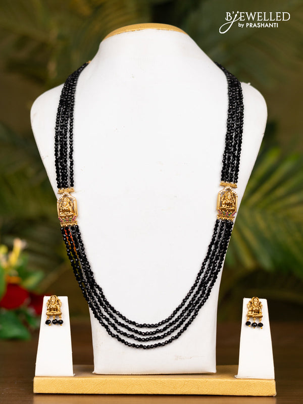 Beaded black necklace with antique lakshmi pendant in white stones