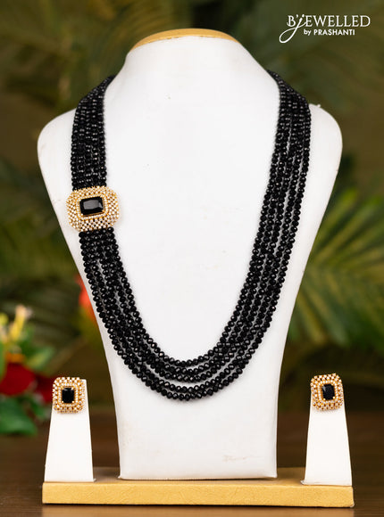 Beaded black necklace with white stones pendant