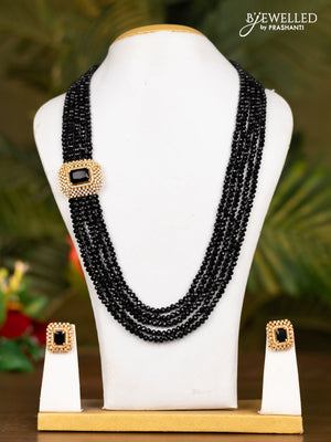 Beaded black necklace with white stones pendant