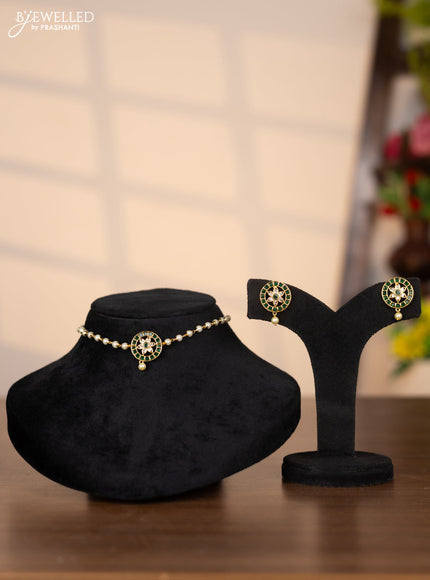 Pearl choker with floral pendant in green stones