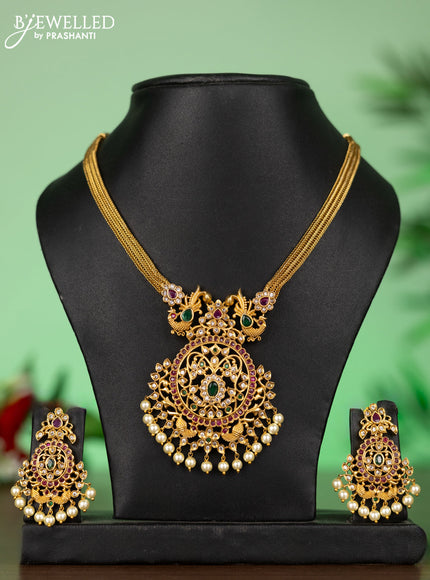 Attigai necklace with floral pendant in kemp ,white and green stones and pearl hanging