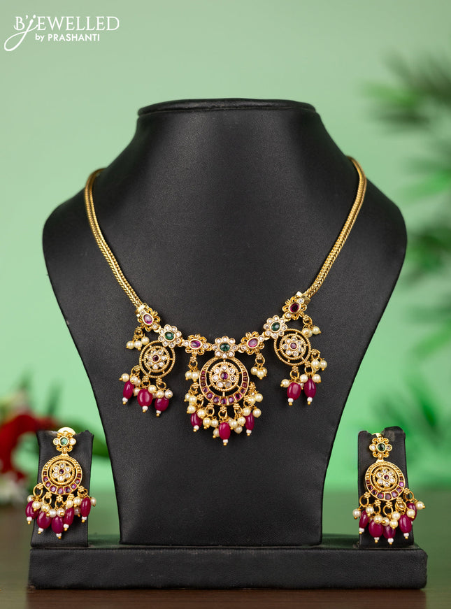 Attigai necklace with floral pendant in kemp ,white and green stones and pink beads hanging