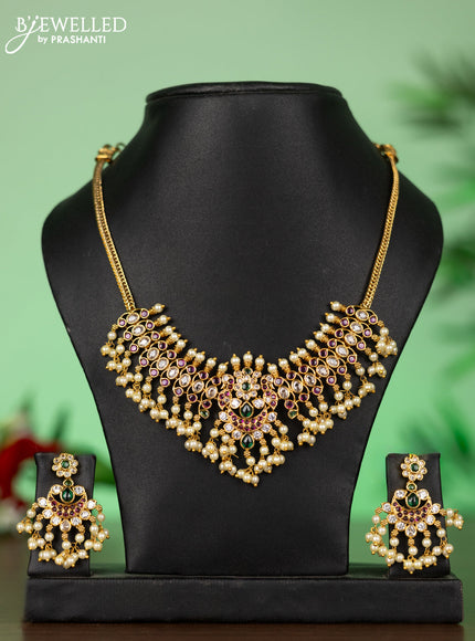 Attigai necklace with chandbali pendant in kemp,green stones and pearl hangings