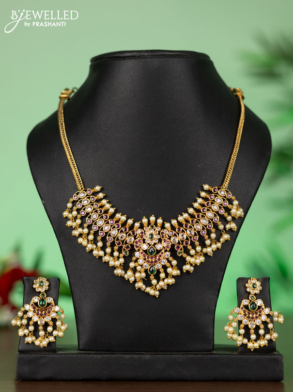 Attigai necklace with chandbali pendant in kemp,green stones and pearl hangings