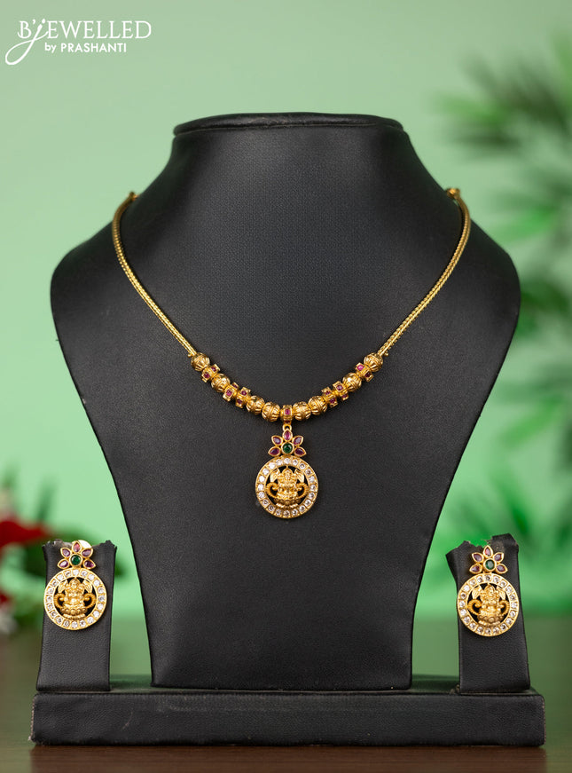 Attigai necklace with lakshmi pendant in kemp and green stones