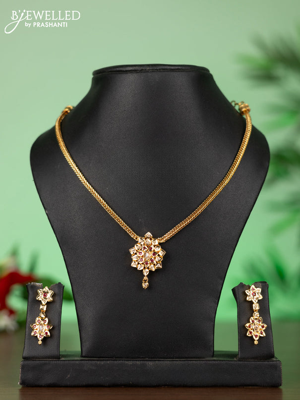 Attigai impon necklace with floral pendant in red,green and white stones