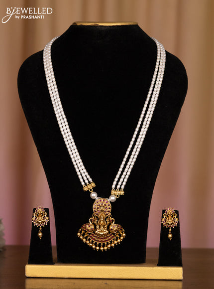 Pearl white haaram with lakshmi pendant in fully kemp stones and golden ball hanging