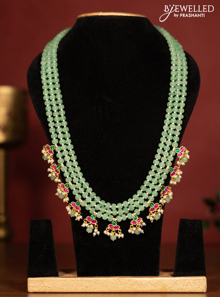 Beaded triple layer mint green necklace with jadau stones pendant and pearl & beads hanging without earrings