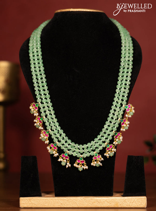 Beaded triple layer mint green necklace with jadau stones pendant and pearl & beads hanging without earrings