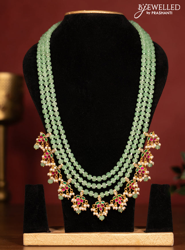 Beaded triple layer mint green necklace with jadau kundan stones pendant and pearl & beads hanging without earrings