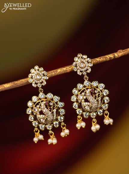 Earrings peacock design with cz stones and pearl hangings in victorian finish