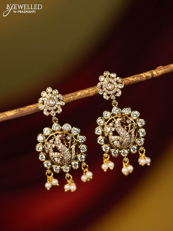 Earrings peacock design with cz stones and pearl hangings in victorian finish