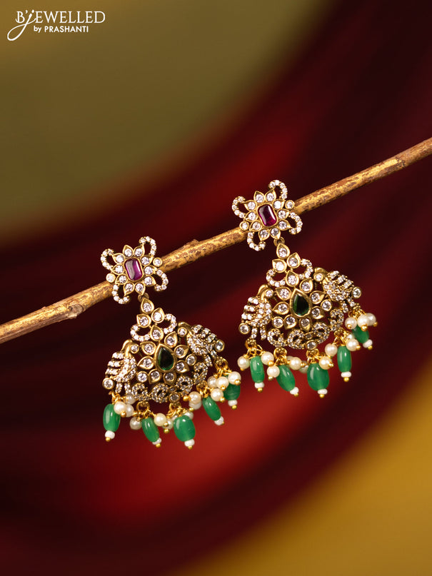 Earrings with kemp & cz stones and beads hanging in victorian finish