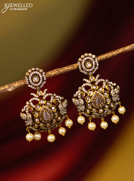 Earrings with baby pink & cz stones and pearl hangings in victorian finish