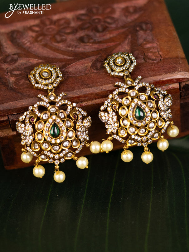 Earrings with emerald & cz stones and pearl hangings in victorian finish