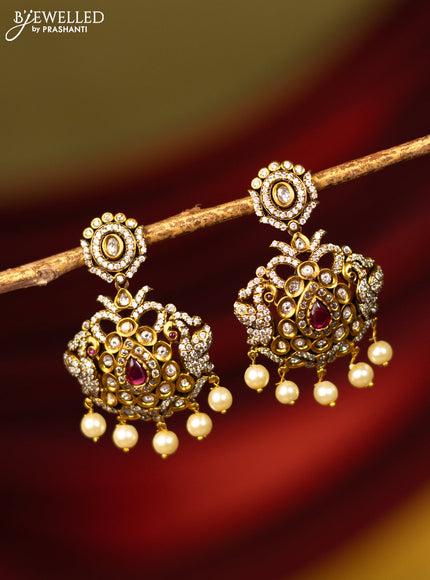 Earrings with ruby & cz stones and pearl hangings in victorian finish