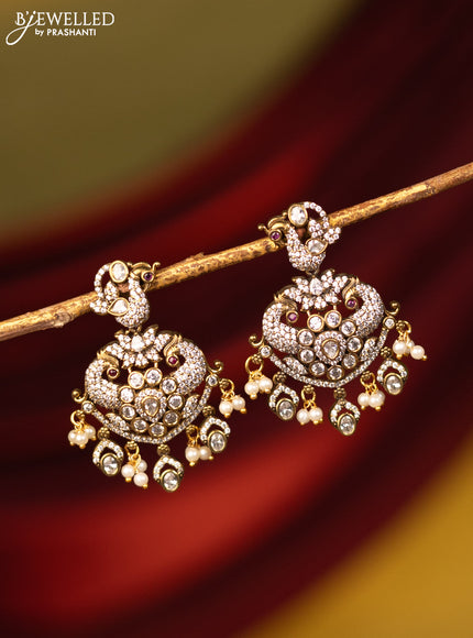 Earrings peacock design with cz stones and pearl hangings in victorian finish