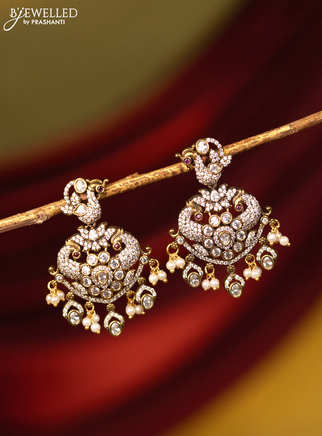 Earrings peacock design with cz stones and pearl hangings in victorian finish