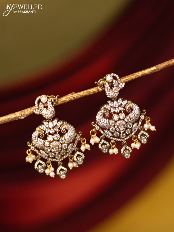 Earrings peacock design with cz stones and pearl hangings in victorian finish