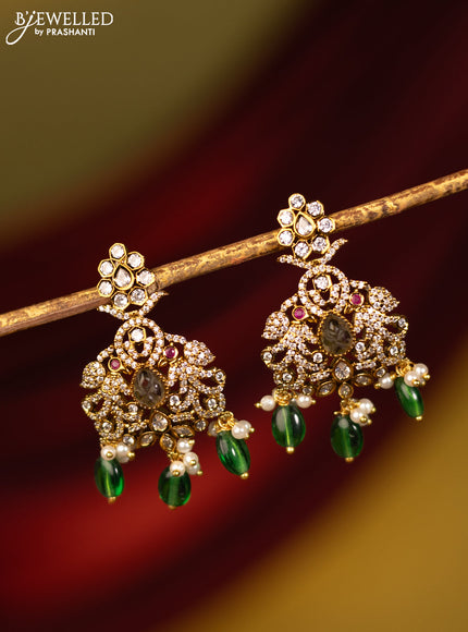 Earrings with cz stones and green beads hanging in victorian finish
