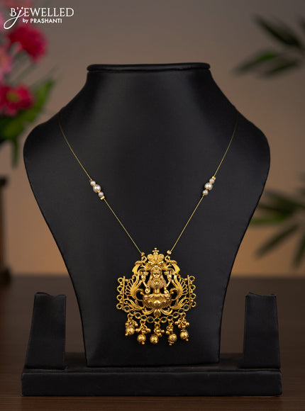 Invisible chain lakshmi pendant with emerald stones and golden beads hanging without earrings