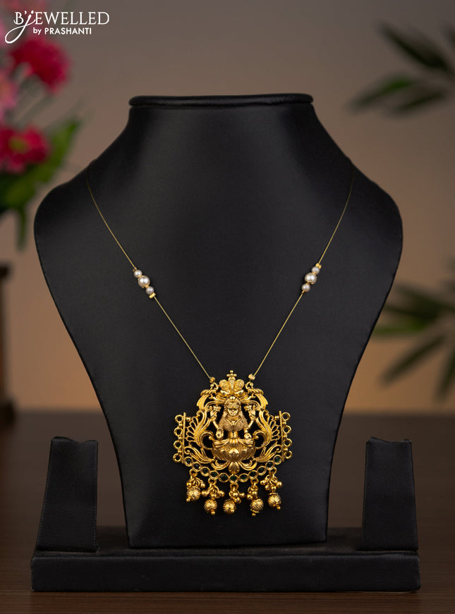 Invisible chain lakshmi pendant with emerald stones and golden beads hanging without earrings