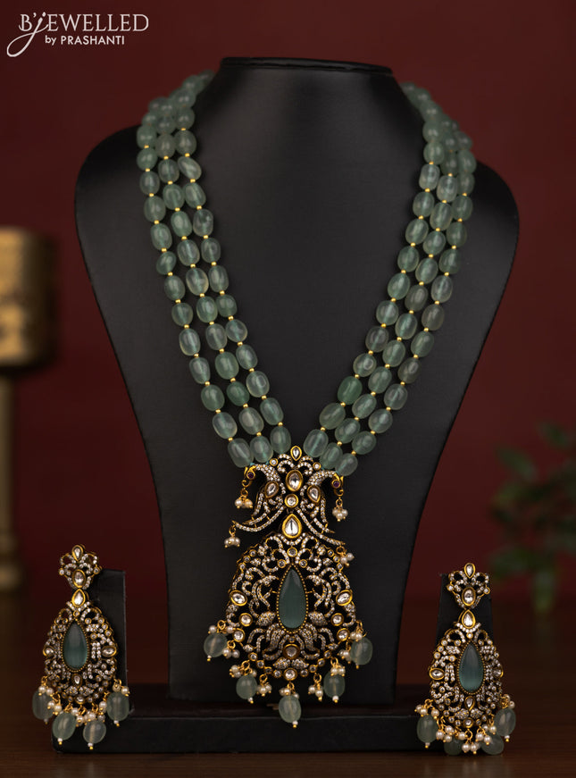 Beaded triple layer mint green necklace peacock pendant with ruby & cz stones and beads hanging in victorian finish