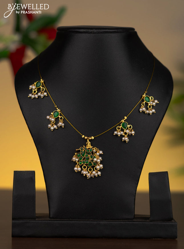 Invisible chain krishna pendant with emerald stones and pearl hangings without earrings