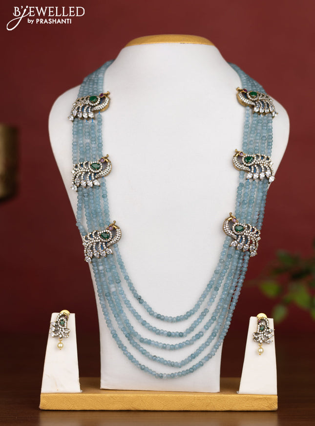 Beaded multilayer light blue necklace with peacock side pendant and kemp & cz stones in victotrian finish