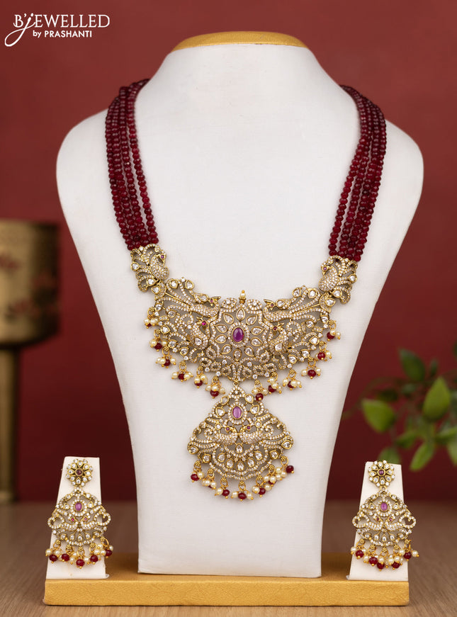 Beaded multilayer maroon haram peacock design with ruby & cz stones and pearl & beads hanging