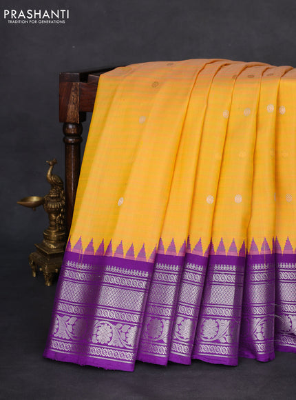 Pure gadwal silk saree dual shade of yellow and violet with allover stripe pattern & zari buttas and temple design simple border