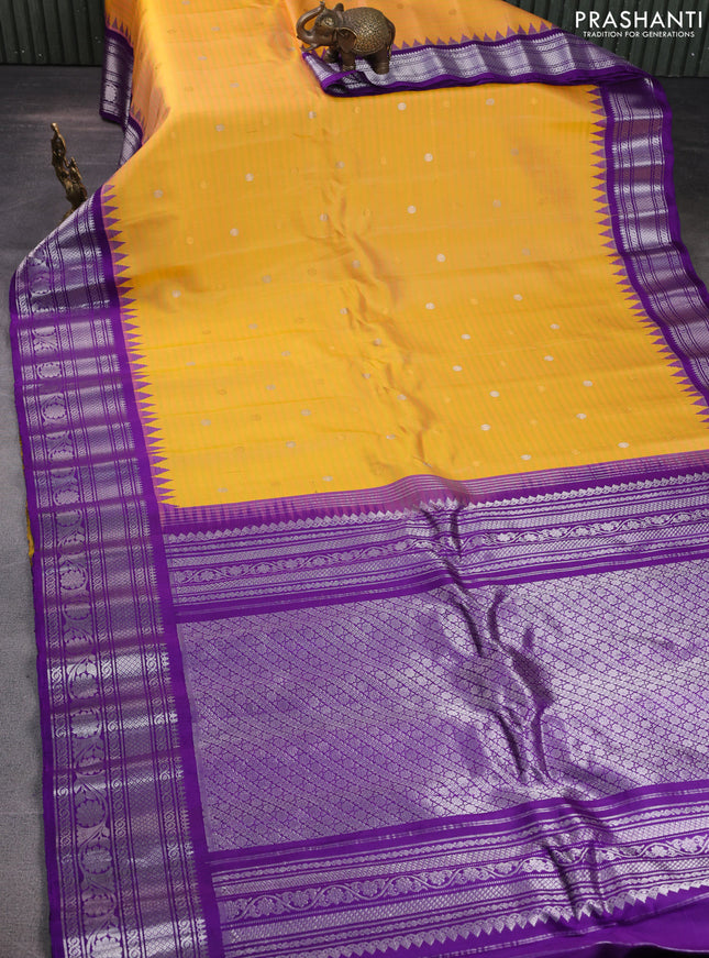 Pure gadwal silk saree dual shade of yellow and violet with allover stripe pattern & zari buttas and temple design simple border