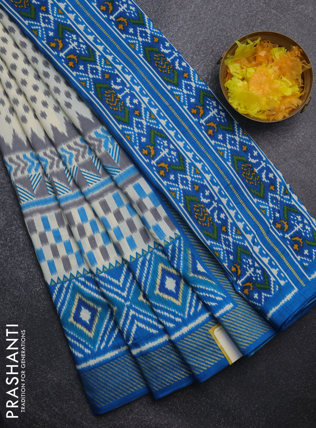 Semi patola saree off white and cs blue with allover ikat weaves and zari woven border