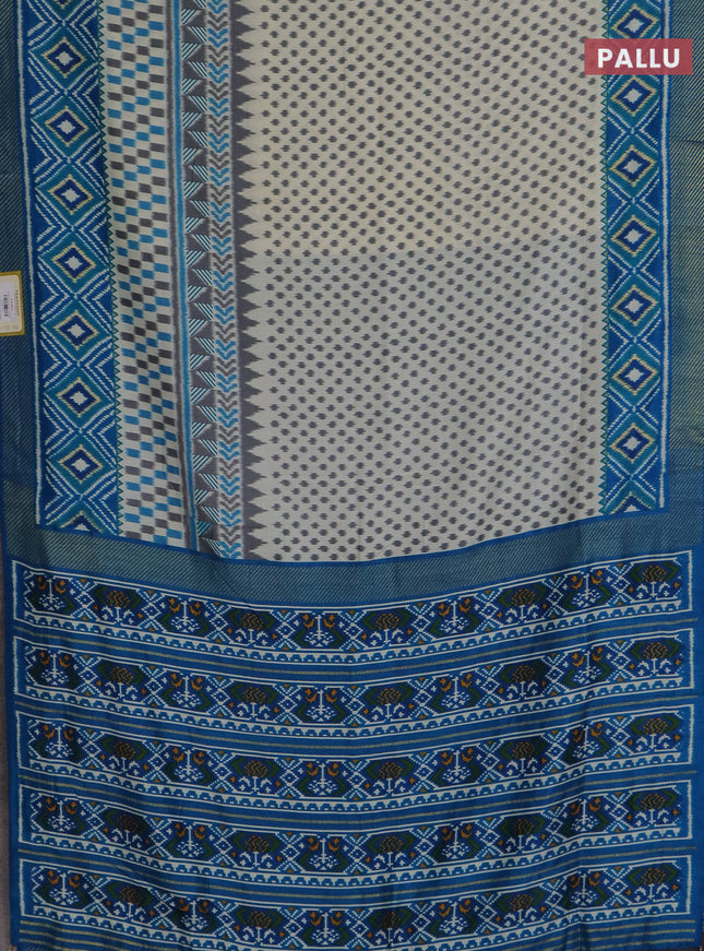 Semi patola saree off white and cs blue with allover ikat weaves and zari woven border