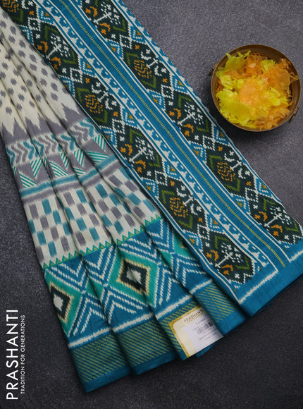 Semi patola saree off white and teal blue with allover ikat weaves and zari woven border