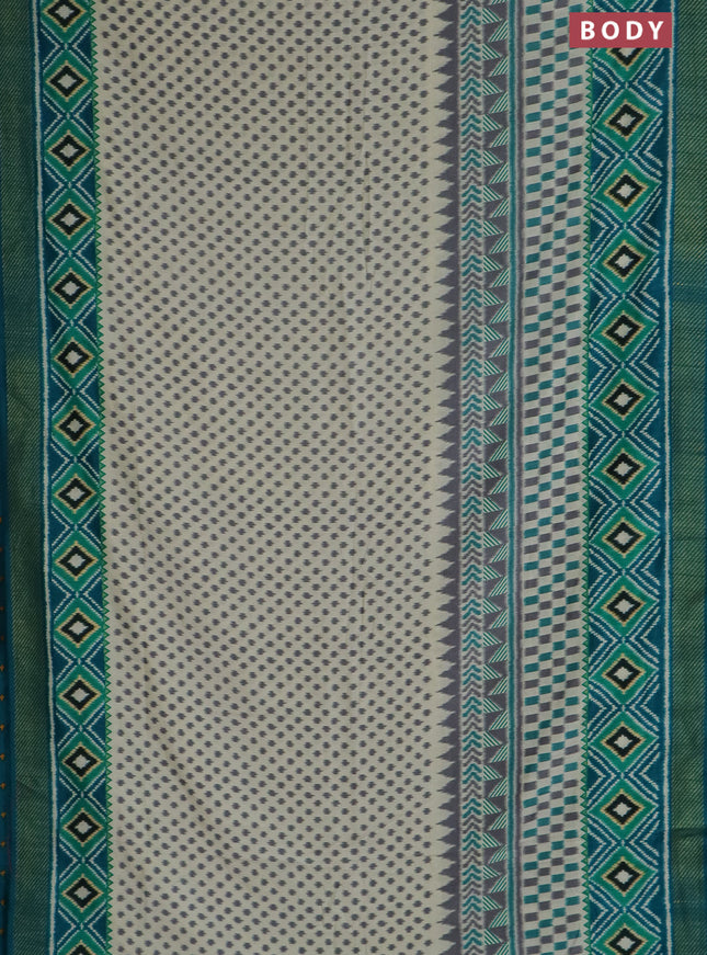 Semi patola saree off white and teal blue with allover ikat weaves and zari woven border
