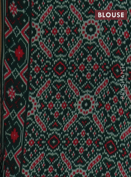 Semi patola saree dark green with allover prints and woven border