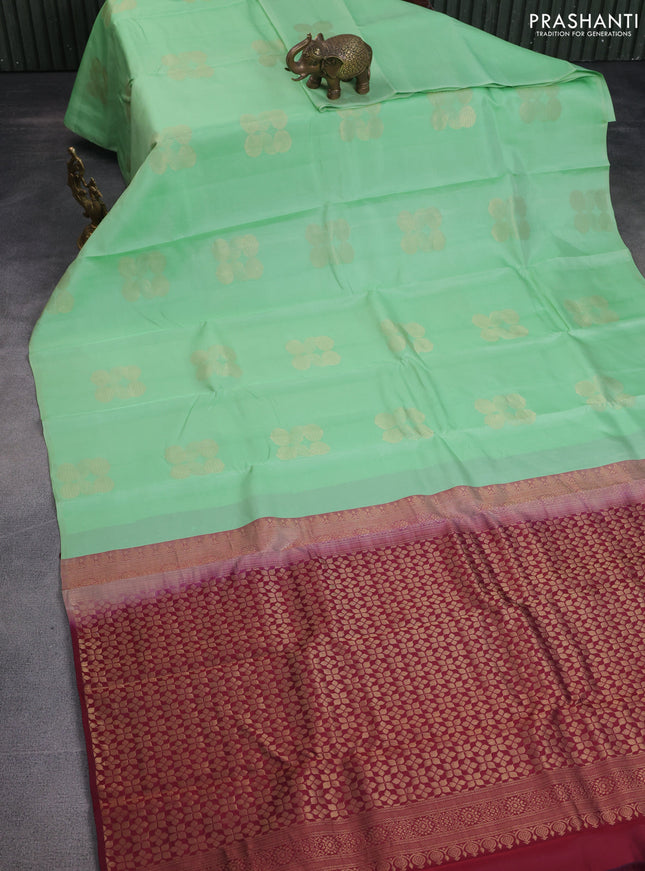 Kanchipuram silk saree pastel green and deep maroon with zari woven geometric buttas in borderless style