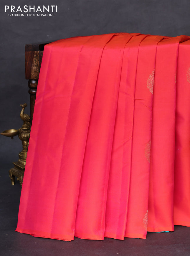 Kanchipuram silk saree dual shade of pinkish orange and teal blue with zari woven buttas in borderless style