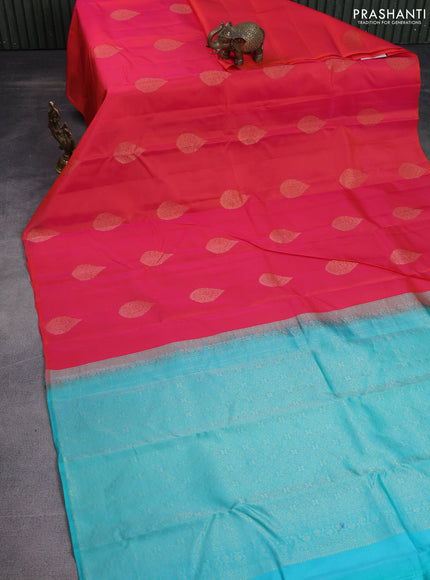 Kanchipuram silk saree dual shade of pinkish orange and teal blue with zari woven buttas in borderless style
