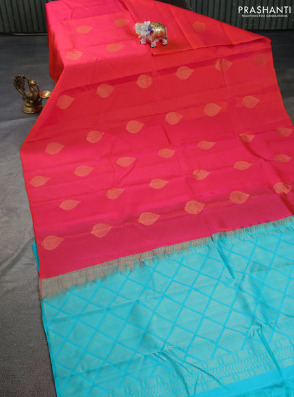 Kanchipuram silk saree dual shade of pinkish orange and teal blue with zari woven buttas in borderless style