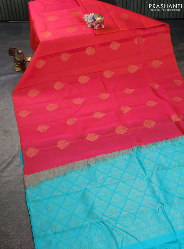 Kanchipuram silk saree dual shade of pinkish orange and teal blue with zari woven buttas in borderless style
