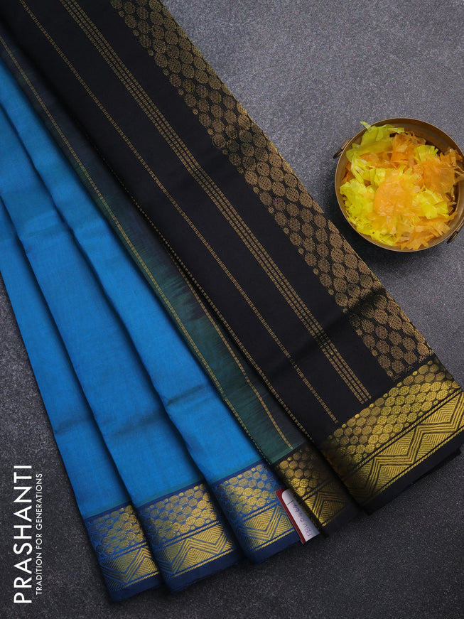 Silk cotton saree dual shade of bluish green and black with plain body and zari woven border