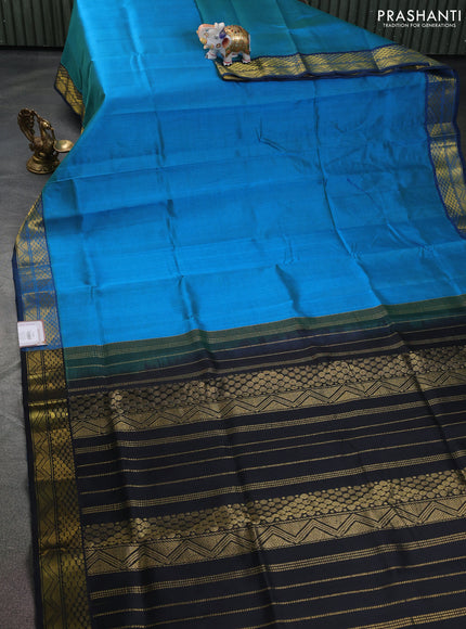 Silk cotton saree dual shade of bluish green and black with plain body and zari woven border