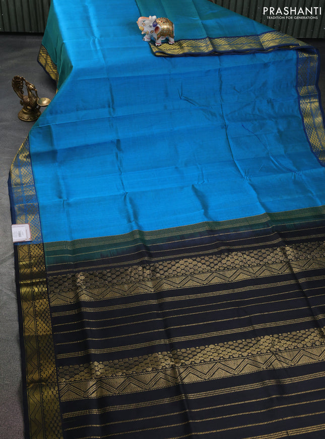 Silk cotton saree dual shade of bluish green and black with plain body and zari woven border