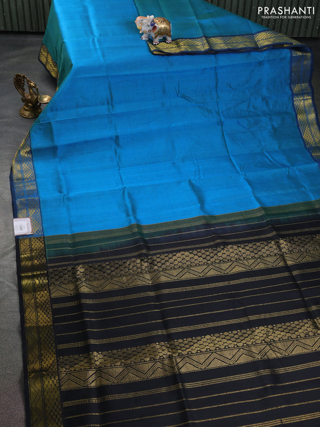 Silk cotton saree dual shade of bluish green and black with plain body and zari woven border