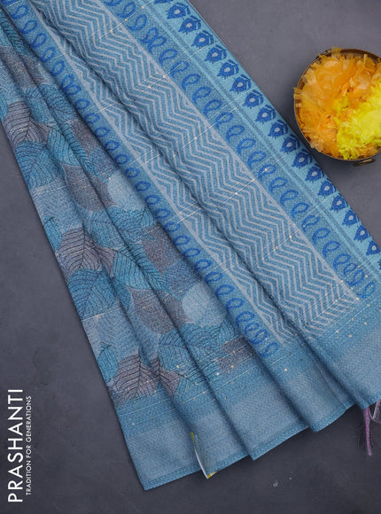 Linen cotton saree teal blue with allover leaf prints & sequin work and silver zari woven border